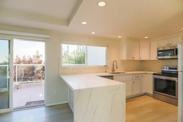 a kitchen with a sink stove and cabinets