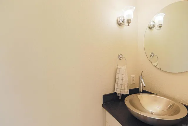 a bathroom with a sink and mirror