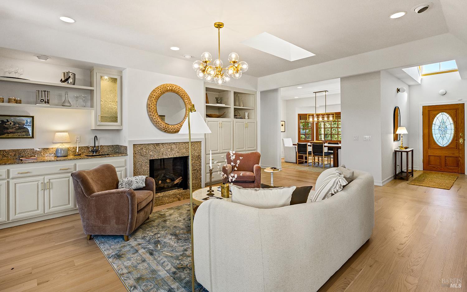 735 Johnson Street Healdsburg, CA 95448 - Photo 15 of 61 a living room with furniture a fireplace and a chandelier
