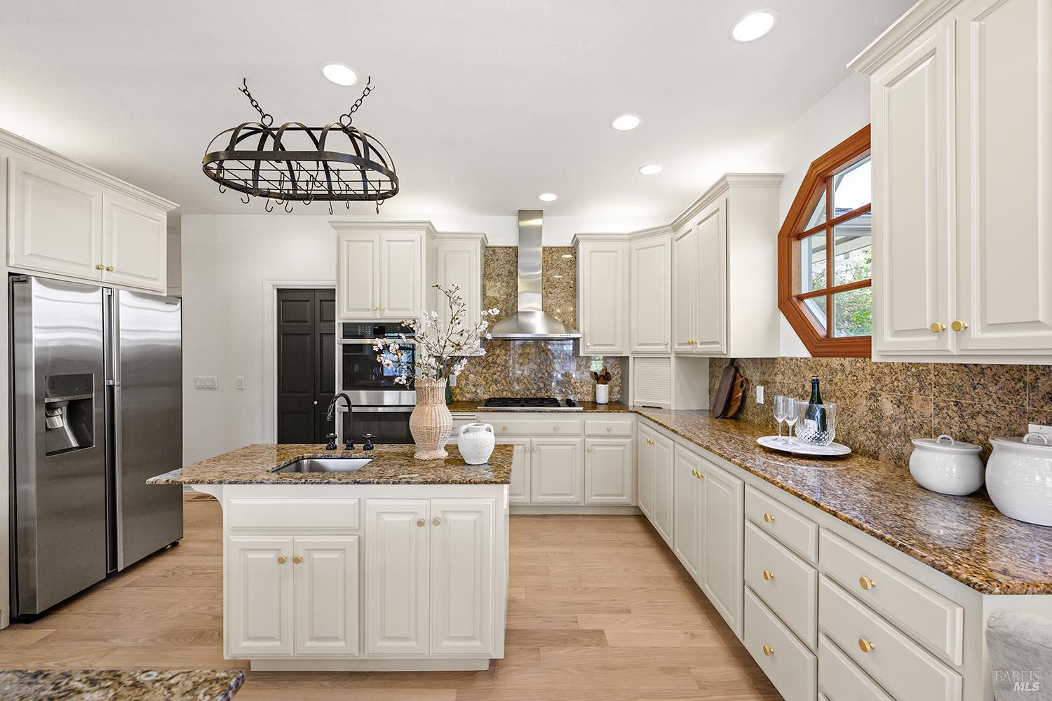 735 Johnson Street Healdsburg, CA 95448 - Photo 24 of 61 a kitchen with stainless steel appliances a sink a counter space and cabinets