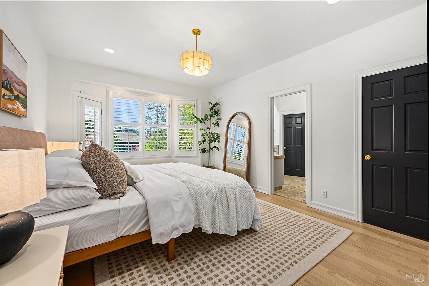 735 Johnson Street Healdsburg, CA 95448 - Photo 31 of 61 a bedroom with a bed lamp and a large window