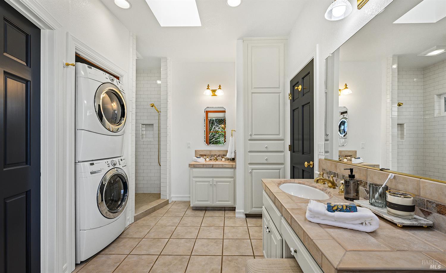 735 Johnson Street Healdsburg, CA 95448 - Photo 32 of 61 a bathroom with a sink a washer and dryer