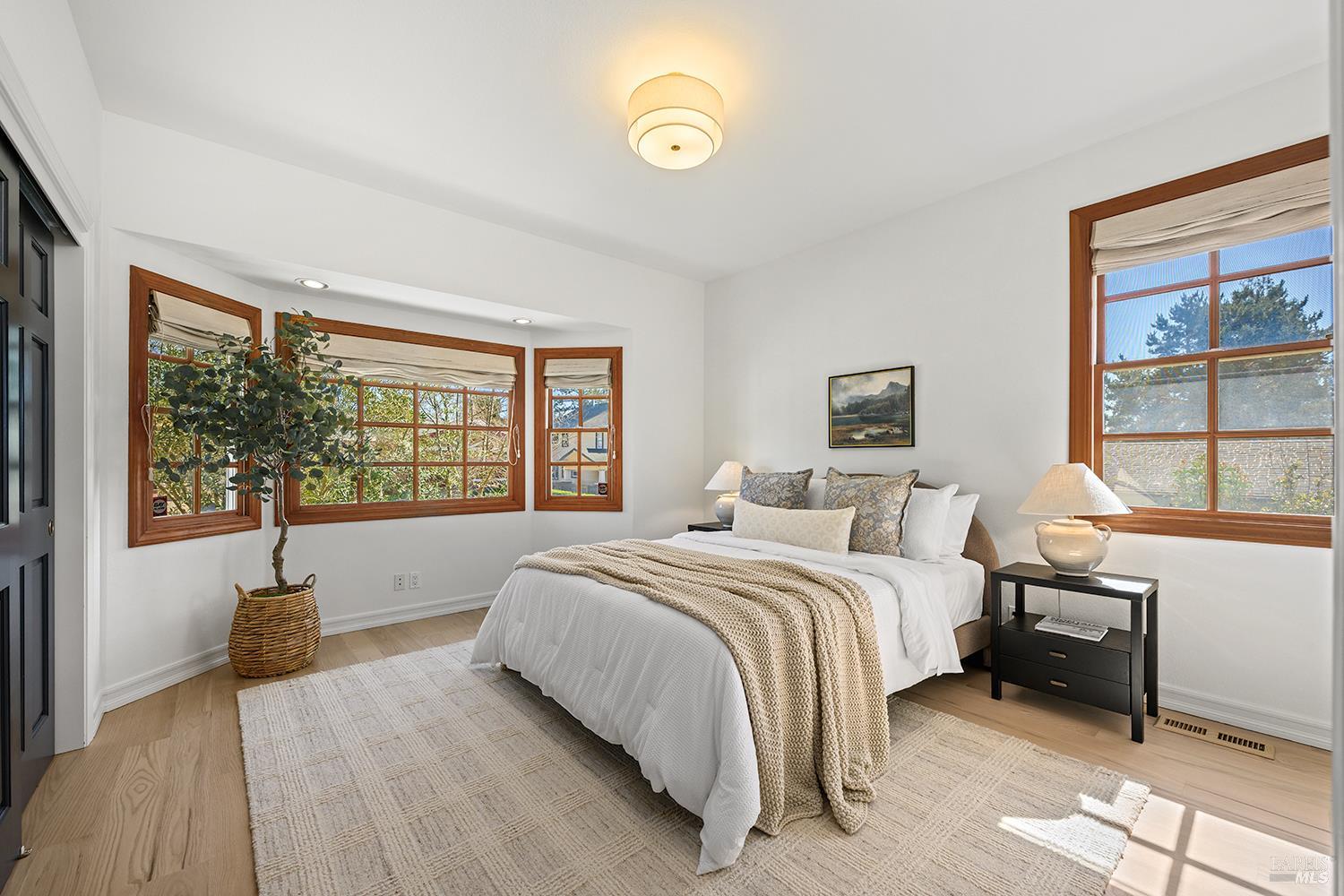 735 Johnson Street Healdsburg, CA 95448 - Photo 37 of 61 a spacious bedroom with a bed and a large window