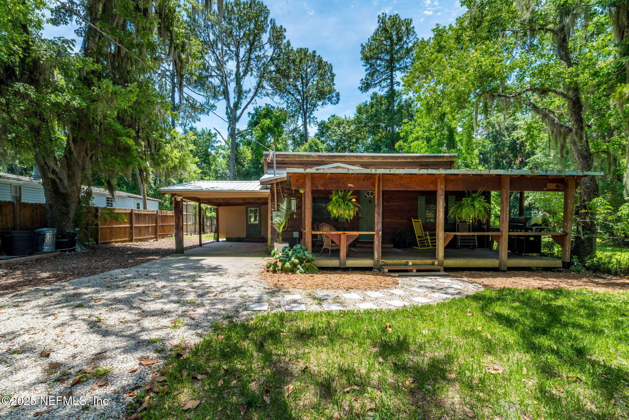 a view of a house with a yard and sitting area