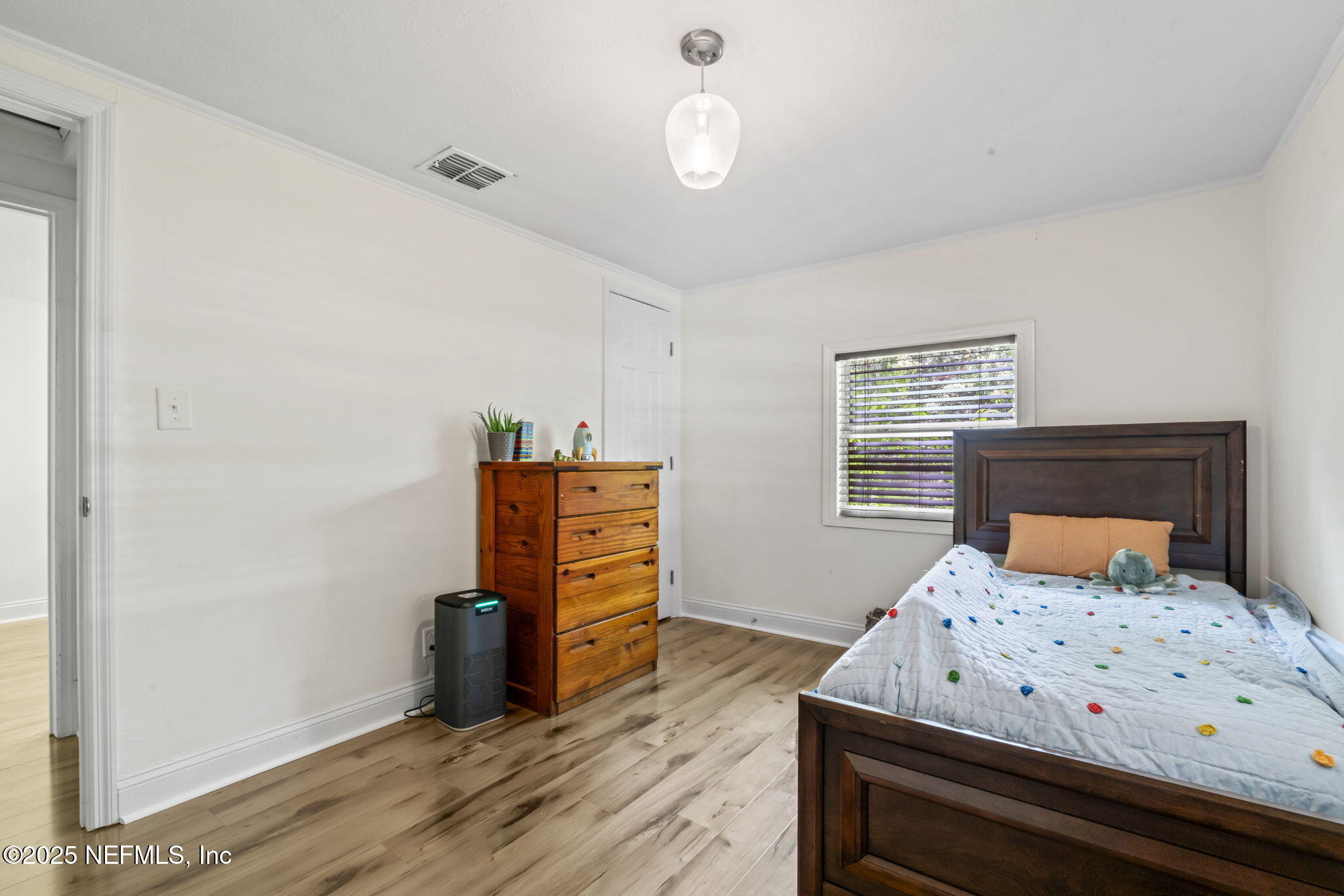 9160 Wild Road Jacksonville, FL 32220 - Photo 21 of 39 a bedroom with a bed and wooden floor