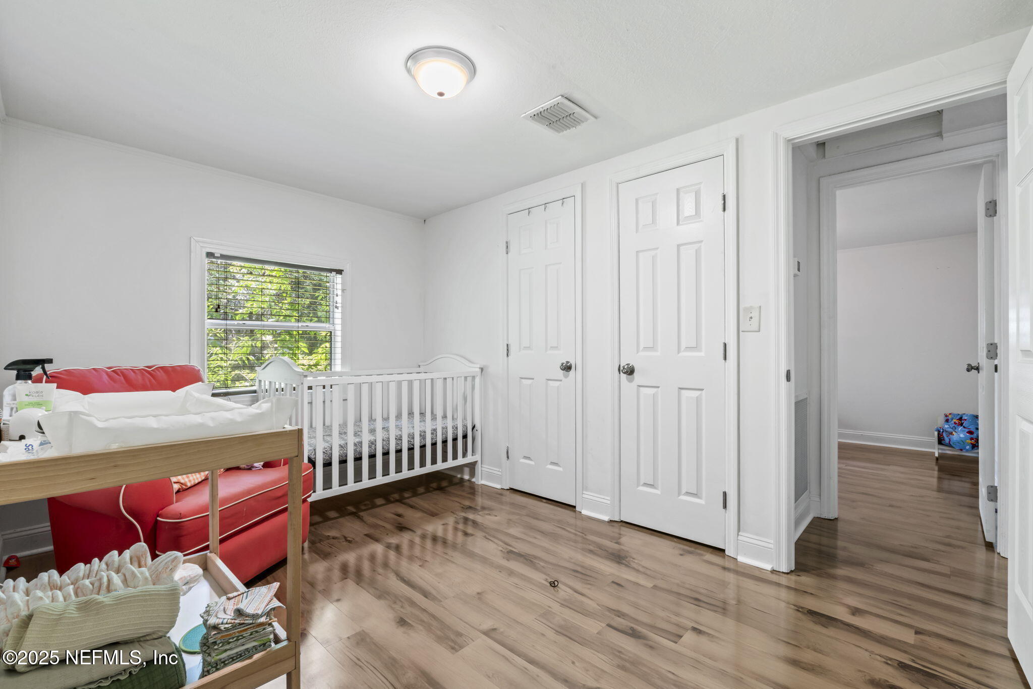 9160 Wild Road Jacksonville, FL 32220 - Photo 22 of 39 a bedroom with baby crib and a window