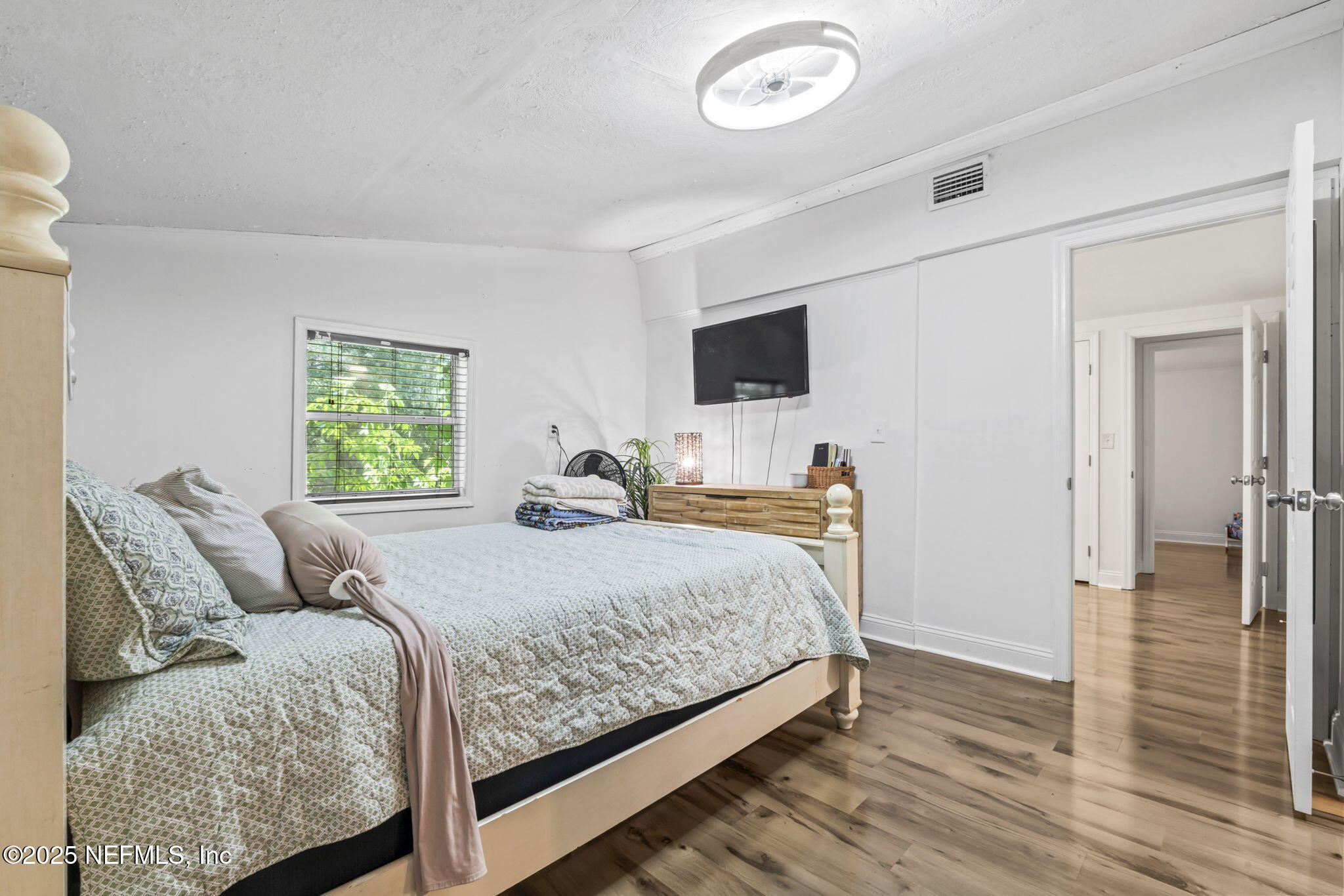 9160 Wild Road Jacksonville, FL 32220 - Photo 26 of 39 a bedroom with a bed and a flat screen tv