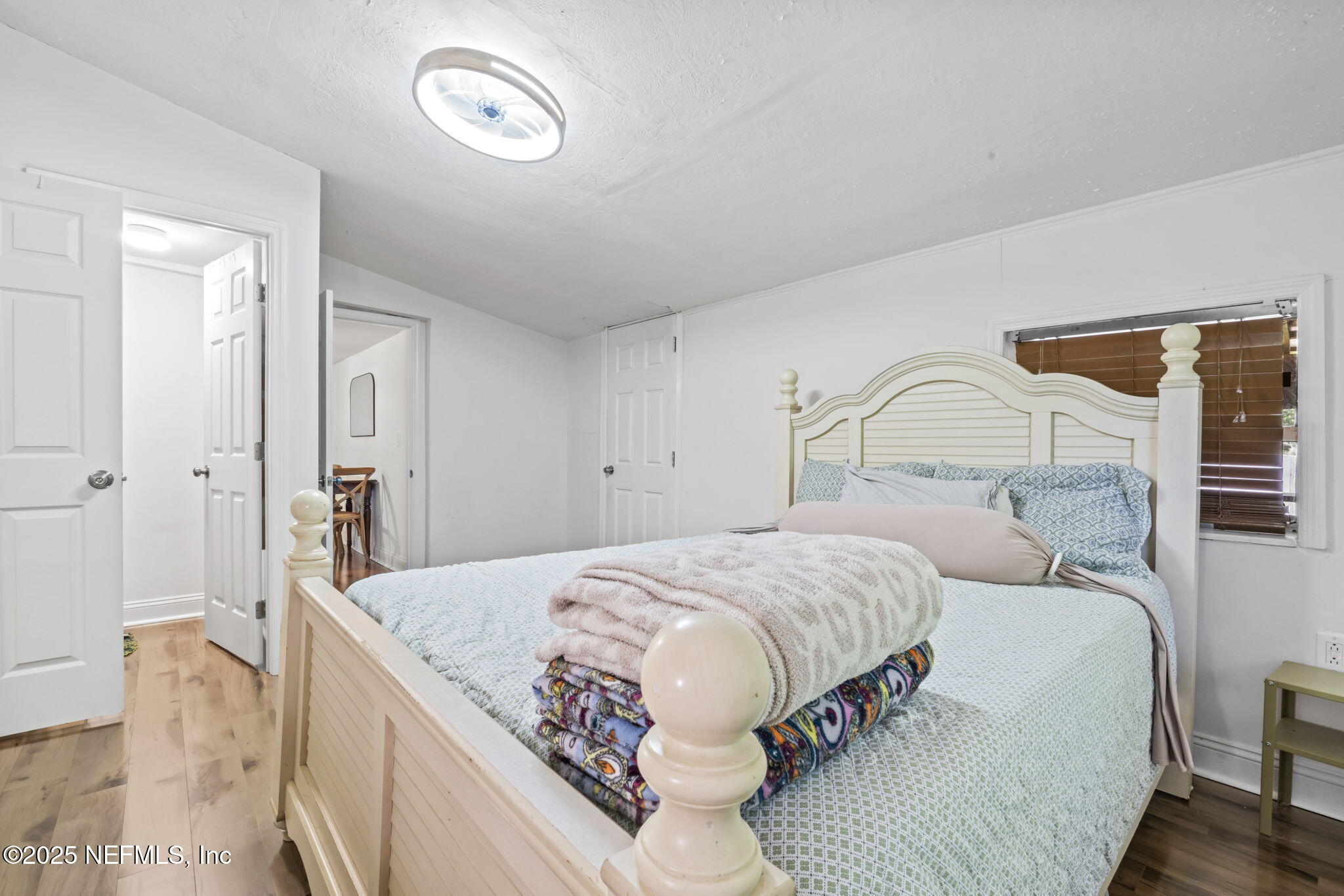9160 Wild Road Jacksonville, FL 32220 - Photo 27 of 39 a bedroom with a large bed and a chandelier