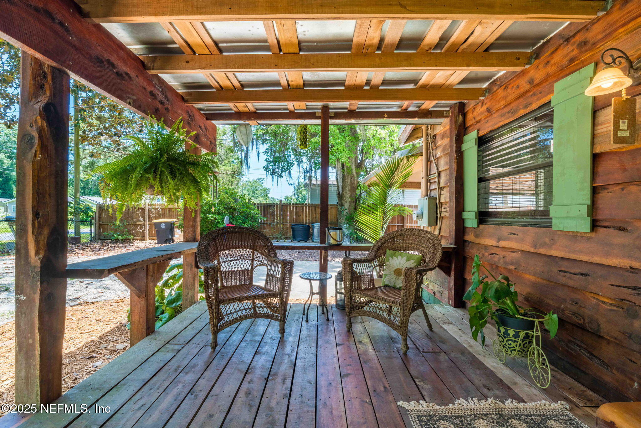 9160 Wild Road Jacksonville, FL 32220 - Photo 8 of 39 a view of a patio with table and chairs and wooden floor
