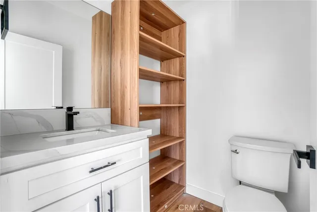 a kitchen with granite countertop a sink a stove and a window