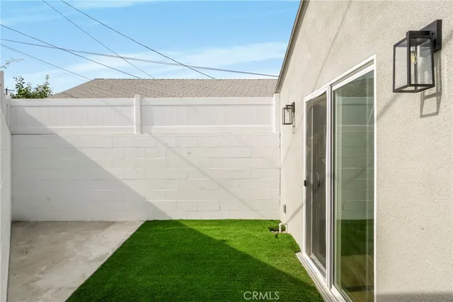 a kitchen with granite countertop a sink stainless steel appliances and window