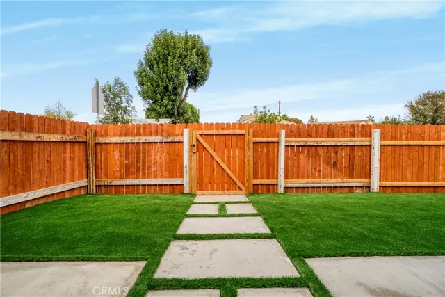 a bathroom with a granite countertop sink toilet a mirror and shower