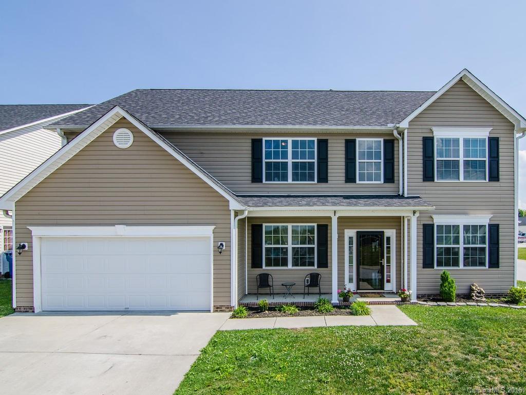 313 Roanoke Road Fletcher, NC 28732 - Photo 1 of 24 a front view of a house with a yard and garage