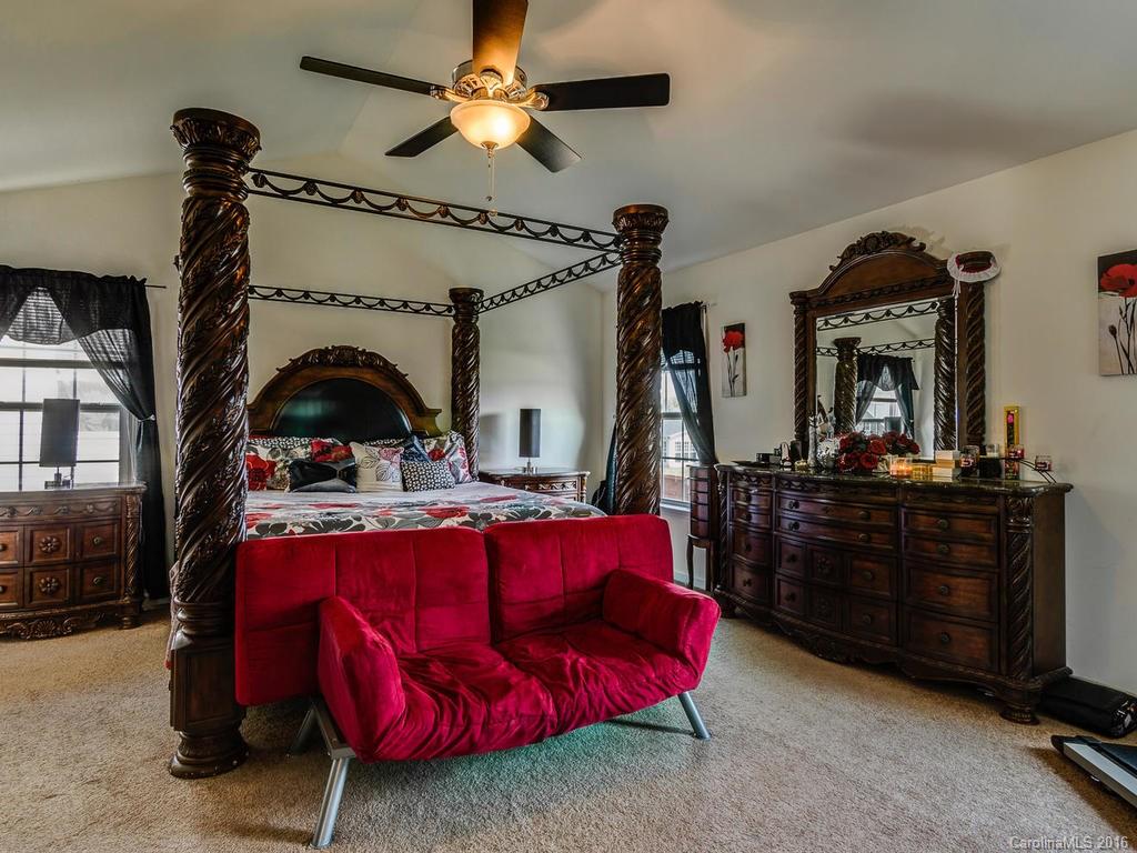 313 Roanoke Road Fletcher, NC 28732 - Photo 18 of 24 a bed room with a bed and a chandelier