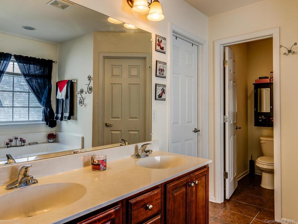 313 Roanoke Road Fletcher, NC 28732 - Photo 19 of 24 a bathroom with a sink double vanity and a toilet