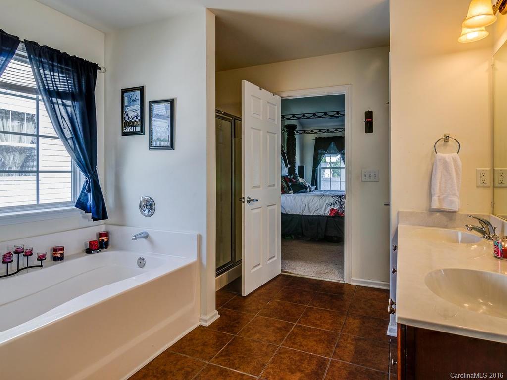 313 Roanoke Road Fletcher, NC 28732 - Photo 20 of 24 a en suite spacious bathroom with a tub sink and mirror