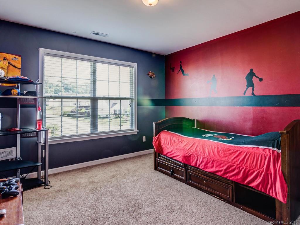 313 Roanoke Road Fletcher, NC 28732 - Photo 21 of 24 a bedroom with a bed dresser and a window