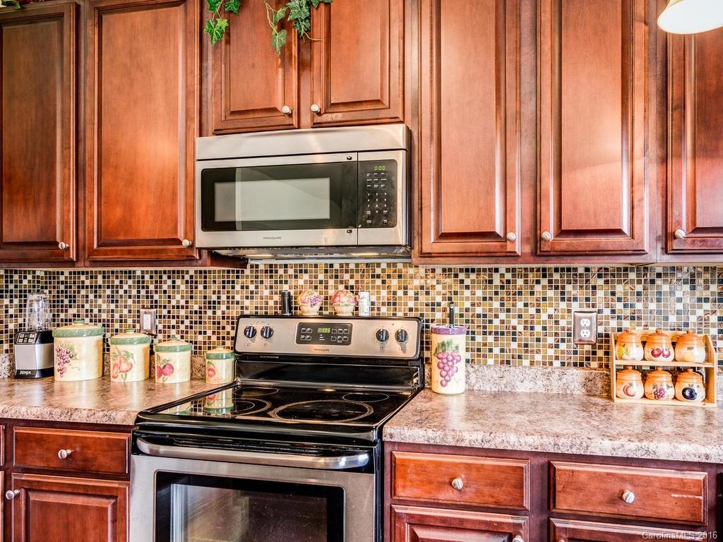 313 Roanoke Road Fletcher, NC 28732 - Photo 10 of 24 a stove top oven sitting inside of a kitchen