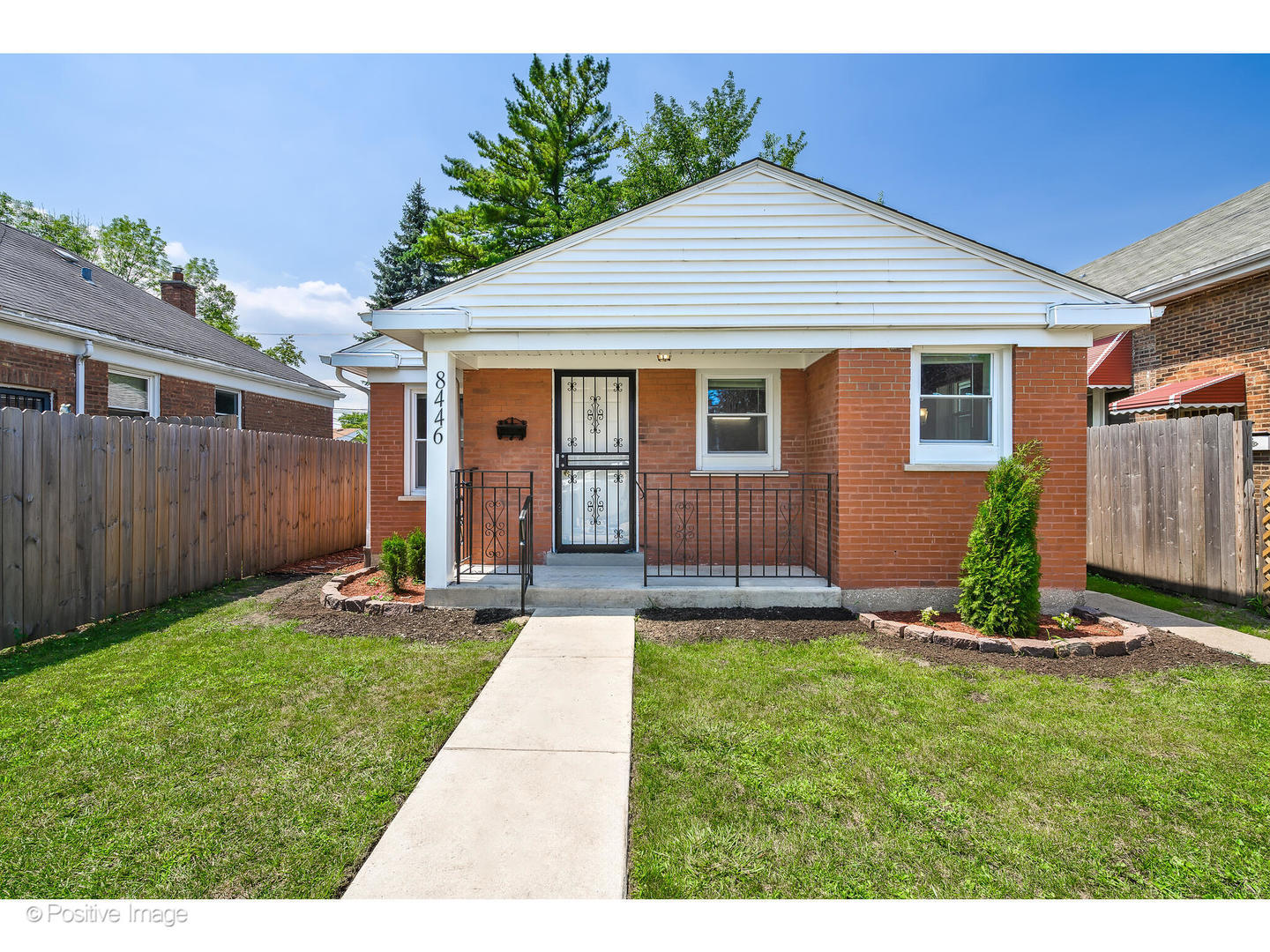 8446 South Constance Avenue Chicago, IL 60617 - Photo 1 of 14 a front view of a house with a yard and porch