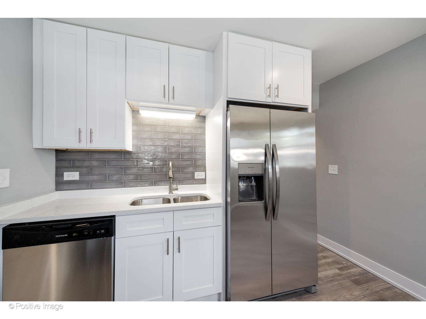 8446 South Constance Avenue Chicago, IL 60617 - Photo 6 of 14 a kitchen with a refrigerator and cabinets