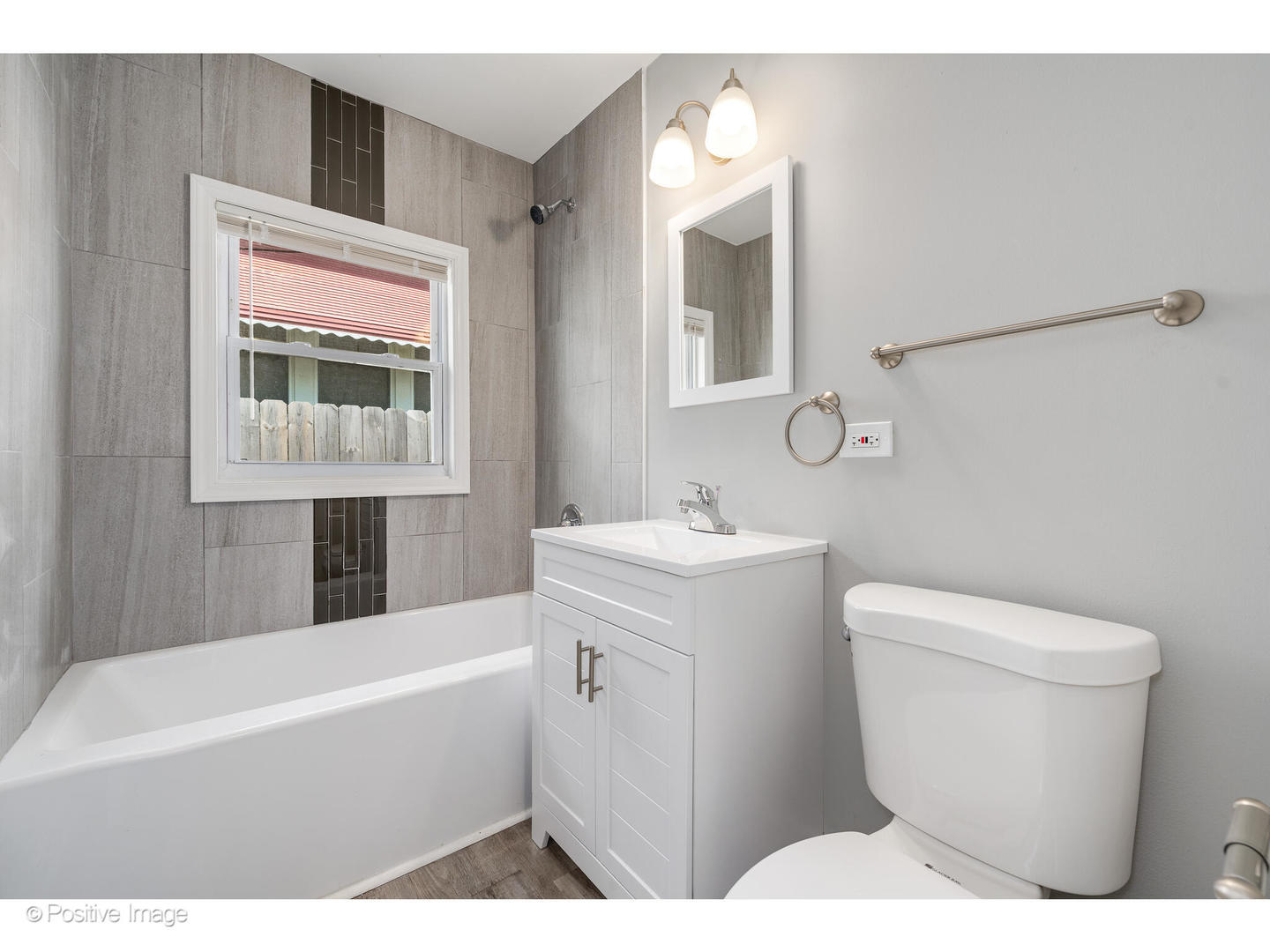 8446 South Constance Avenue Chicago, IL 60617 - Photo 9 of 14 a bathroom with a sink a toilet and bathtub