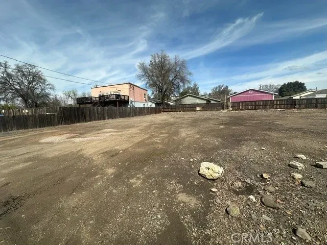 a view of a pathway with a wrought fence