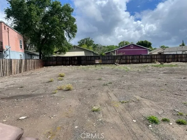 a front view of a house with yard and trees