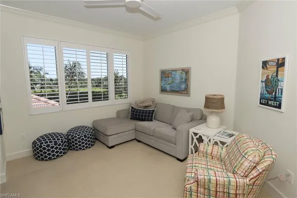 a living room with furniture large window and a lamp