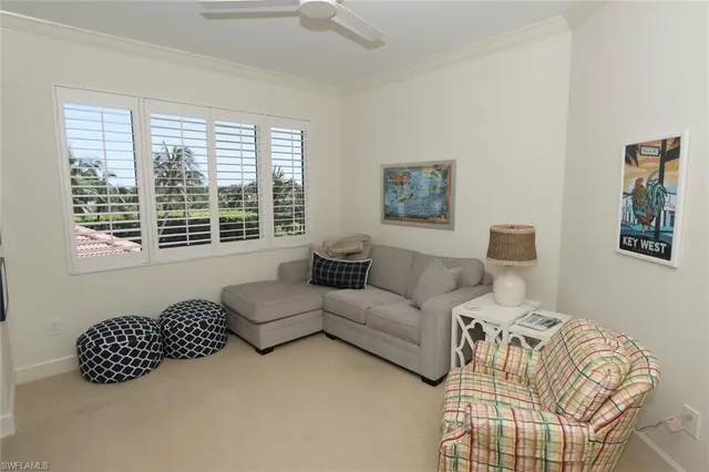 a living room with furniture large window and a lamp