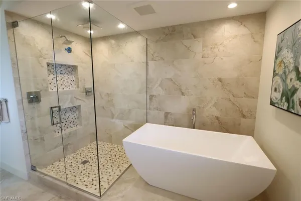 a bathroom with a bathtub and shower