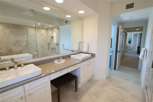 a bathroom with a sink double vanity and a mirror