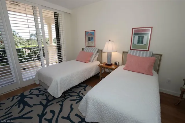 a bedroom with two beds and a window