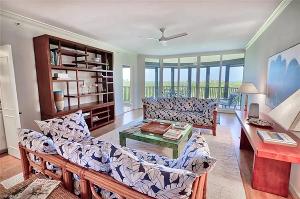a living room with furniture a couch and a bookshelf