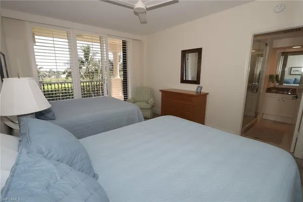 a bedroom with two beds and a window