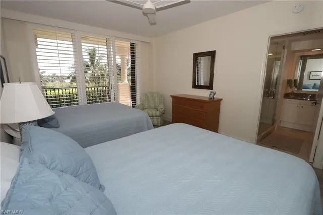 a bedroom with two beds and a window