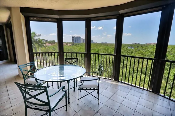 a view of a chairs and table in the balcony