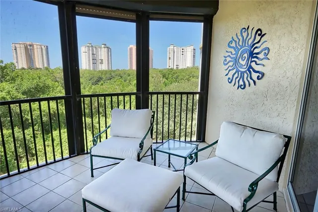 a view of a chairs and table in the balcony