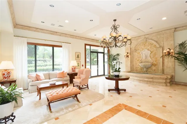 a living room with fireplace furniture and a chandelier