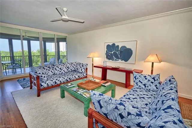 a bedroom with furniture and a large window