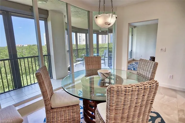 a view of a dining room with furniture wooden floor and chandelier