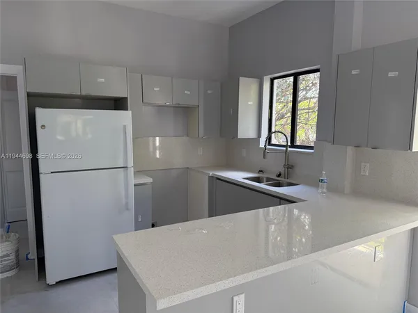 a kitchen with a refrigerator a sink and a stove