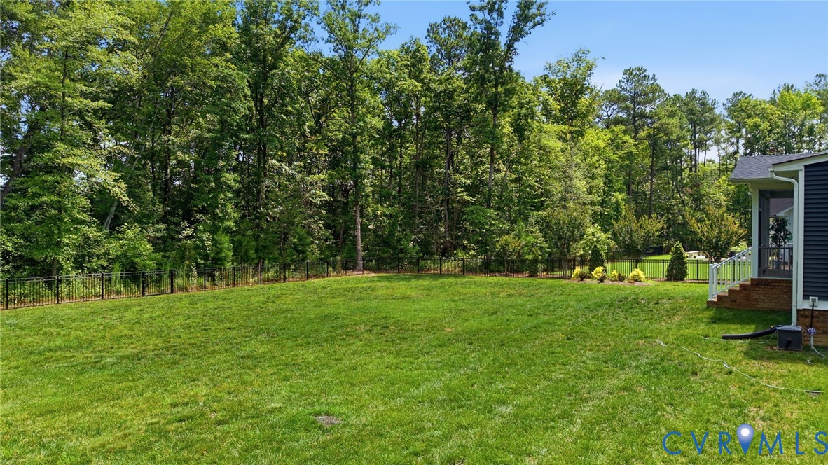 12040 Kenton Ridge Road Ashland, VA 23005 - Photo 47 of 54 Expansive green lawn bordered by a black metal fen