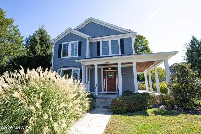 a front view of a house with a garden