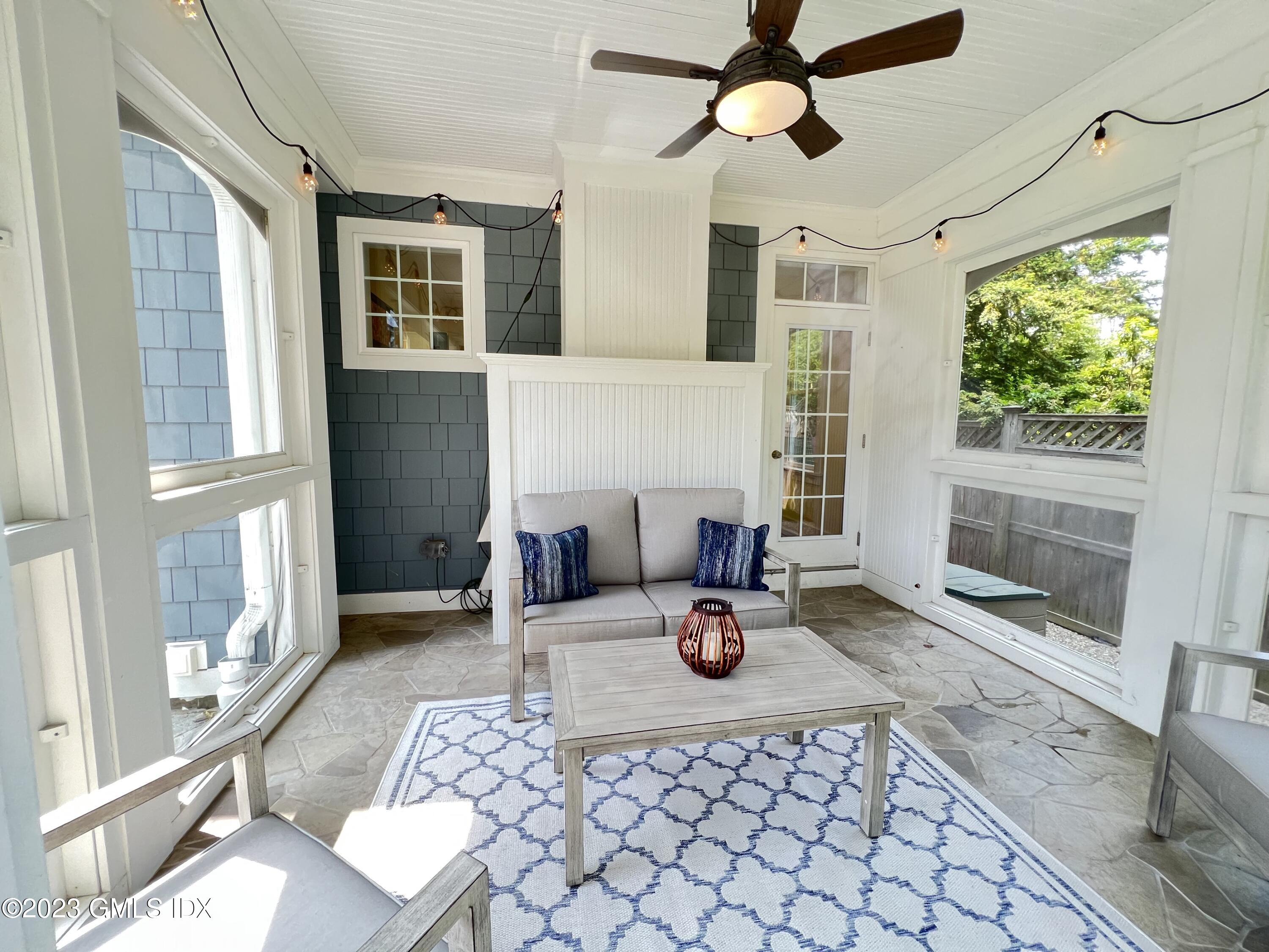 9 Center Road Old Greenwich, CT 06870 - Photo 12 of 26 a living room with furniture a fireplace and a table