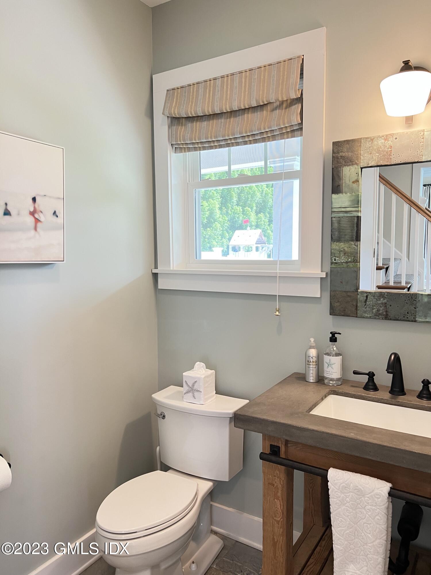9 Center Road Old Greenwich, CT 06870 - Photo 13 of 26 a bathroom with a sink a toilet and a window