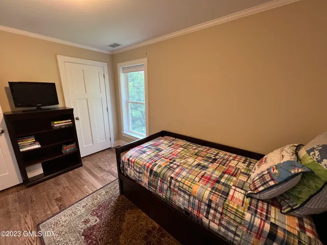 a bedroom with a bed and a tv
