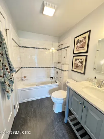 a spacious bathroom with a sink a bathtub and a toilet