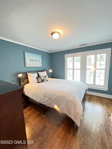 a bedroom with a large bed and a large window
