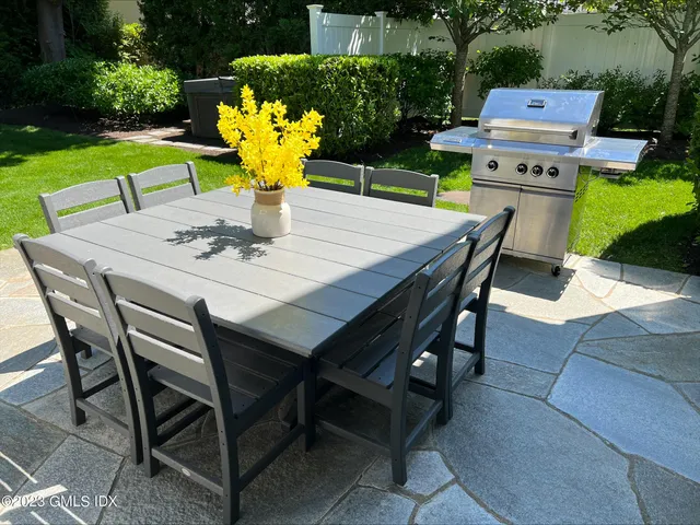 a view of a dining table and chairs in the patio
