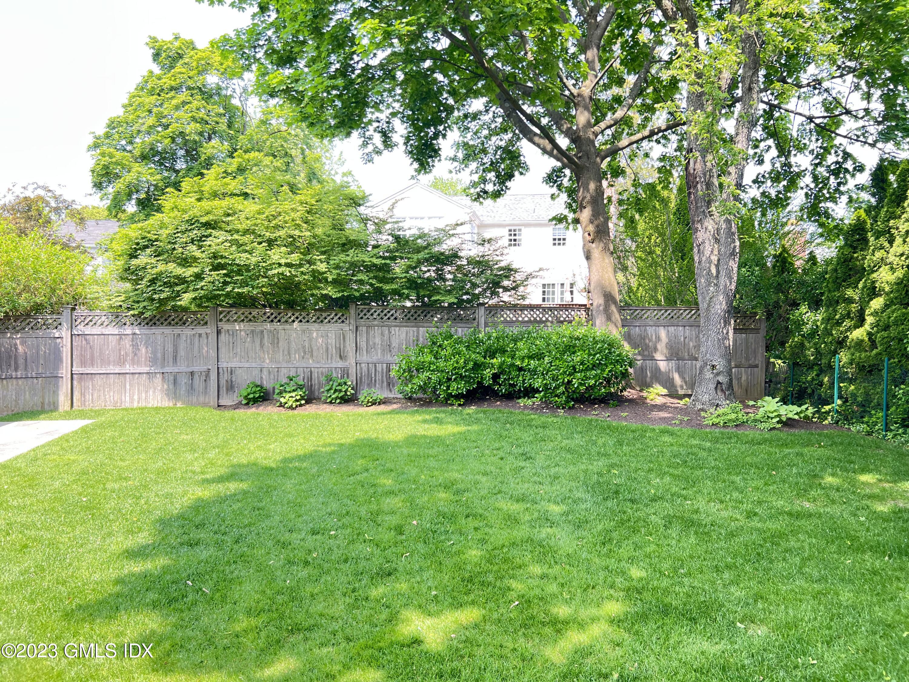 9 Center Road Old Greenwich, CT 06870 - Photo 26 of 26 a view of a backyard with large trees and wooden fence